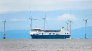 a large ship with windmills in the background representing marine construction industry