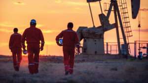 oil workers as part of skilled labor workforce walking on field