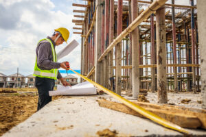 a construction looking over blueprints on a construction site, staffing solutions article